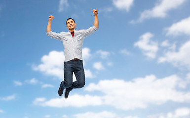 Image showing happy young man jumping over white background