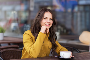 Image showing teenage girl drinking hot chocolate at city cafe