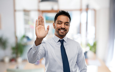 Image showing businessman making high five gesture at office