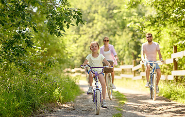 Image showing happy family riding bicycles in summer park