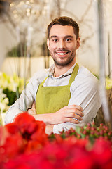 Image showing florist man or seller at flower shop counter