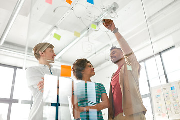 Image showing happy creative team at office glass board