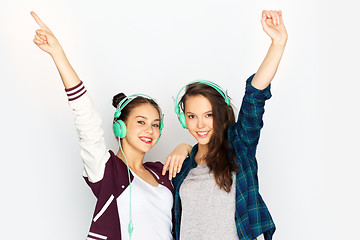 Image showing teenage girls in earphones listening to music