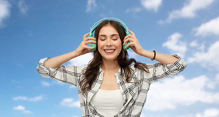 Image showing happy young woman or teenage girl with headphones