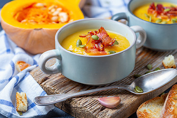 Image showing Pumpkin soup with crispy bacon close up.