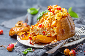 Image showing Sliced pumpkin stuffed with couscous and vegetables.