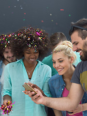 Image showing confetti party multiethnic group of people isolated over gray