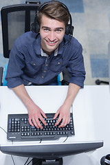 Image showing male call centre operator doing his job top view