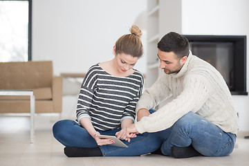 Image showing Young Couple using digital tablet on cold winter day