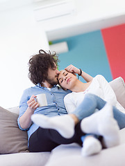 Image showing Young couple on the sofa watching television