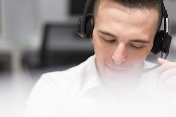 Image showing male call centre operator doing his job