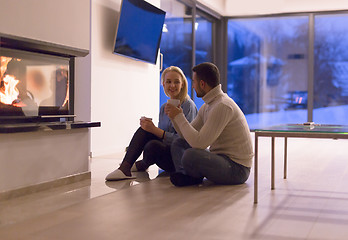 Image showing happy couple in front of fireplace