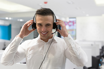 Image showing male call centre operator doing his job