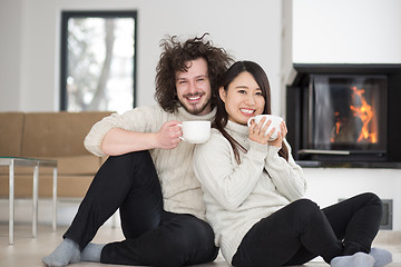 Image showing happy multiethnic couple  in front of fireplace