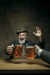 Image showing Smiling bearded male drinking beer in pub