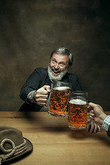 Image showing Smiling bearded male drinking beer in pub