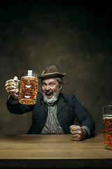 Image showing Smiling bearded male drinking beer in pub