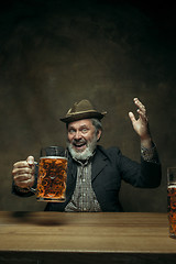 Image showing Smiling bearded male drinking beer in pub