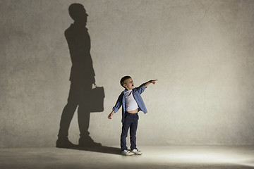 Image showing The little boy dreaming about businessman profession