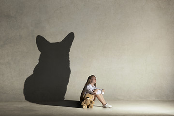 Image showing Baby girl dreaming about dog