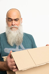 Image showing skeptical looking bearded man with a carton box