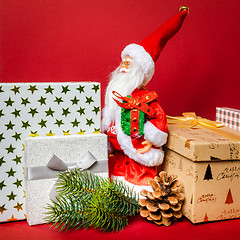 Image showing Santa Claus figure standing on a golden gift box