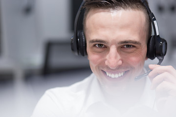 Image showing male call centre operator doing his job
