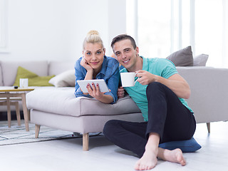 Image showing couple relaxing at  home with tablet computers