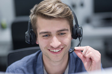 Image showing male call centre operator doing his job