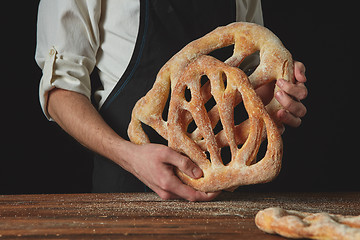 Image showing Baker is holding fougas bread