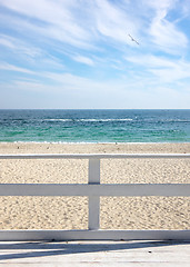 Image showing View on a morning seascape with blue cloudy sky and sea from wooden deck.