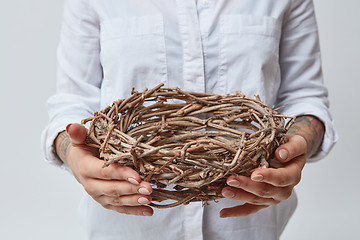 Image showing Young girl holding a nest of branches