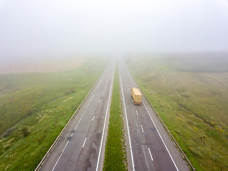 Image showing Aerial view from the drone a misty morning on the road with a tr