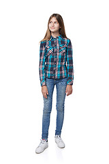 Image showing Teen girl in checkered shirt standing casually