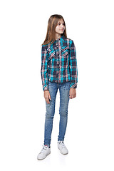 Image showing Teen girl in checkered shirt standing casually