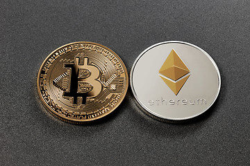 Image showing Two coins bitcoin and ethereum on a dark background. Business concept