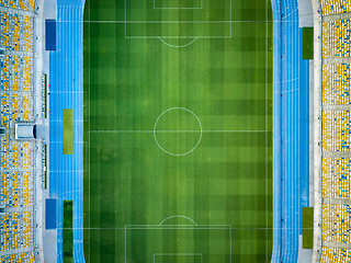 Image showing KYIV, UKRAINE - July 19, 2018. NSC Olimpiysky. Aerial view from drone of construction of green football field, tribunes before the game. Top view