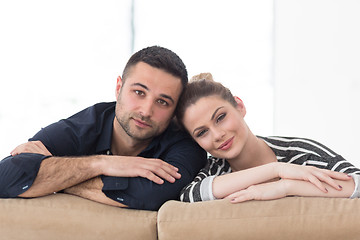 Image showing Portrait of young couple sitting on sofa