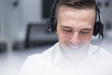 Image showing male call centre operator doing his job