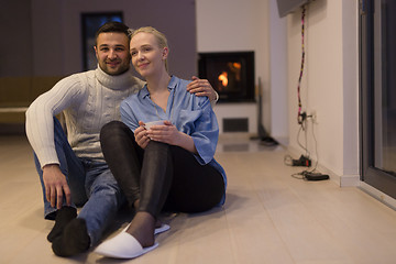 Image showing happy couple in front of fireplace