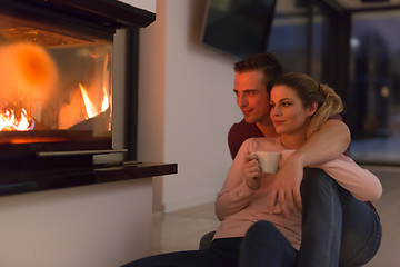 Image showing happy couple in front of fireplace