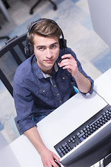 Image showing male call centre operator doing his job top view