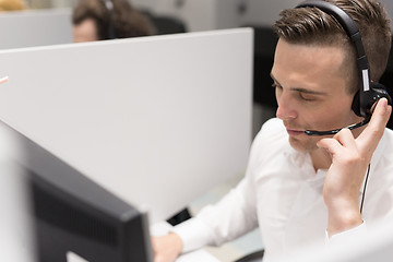 Image showing male call centre operator doing his job