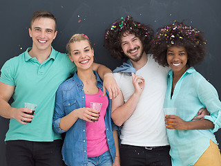 Image showing confetti party multiethnic group of people isolated over gray