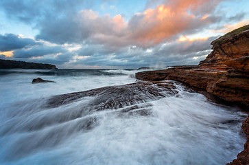 Image showing Waves crash onto the rocky shore of Bare Island