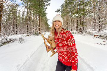 Image showing Happy cheerful woman at Christmas among snowy pine trees