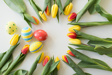 Image showing close up of colored easter eggs and tulip flowers