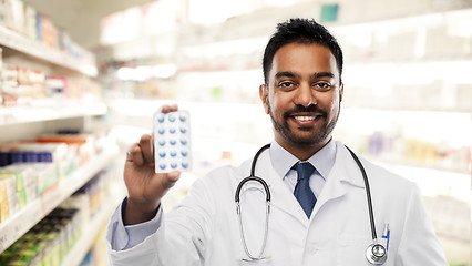 Image showing indian male doctor or pharmacist with pills