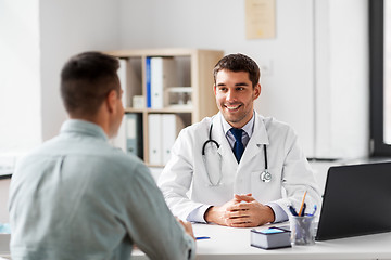 Image showing doctor with laptop and male patient at hospital