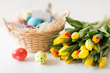 Image showing close up of colored easter eggs and tulip flowers